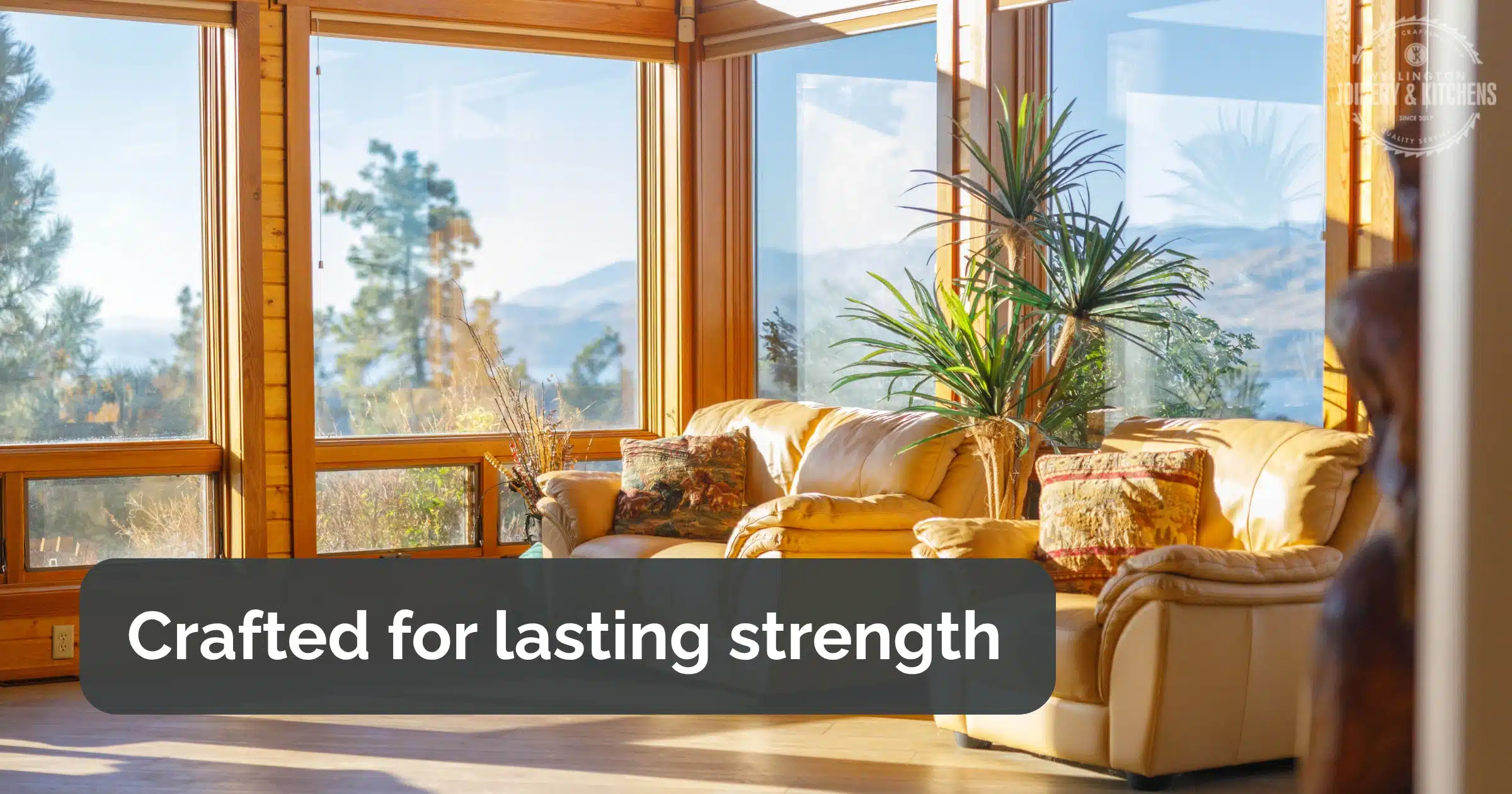 Timber-framed sunroom with large windows and mountain views.